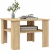 A wooden coffee table with books and a plant. Produktbild-Vorschau