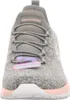 A close-up front view of a gray and pink Skechers sneaker. Voir les images du produit