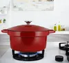 A red Dutch oven sits on a white gas stovetop with a blue flame. Podgląd zdjęcia produktu