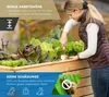 A woman is gardening in a raised wooden planter box filled with various vegetables. Náhled obrázku produktu