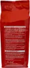 The back of a red coffee bag with text and a signature. Náhľad obrázku produktu