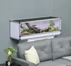 A terrarium with a snake inside is mounted on a wall above a sofa. Produktbild-Vorschau