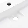 A close-up view of a white sink with two holes. Podgląd zdjęcia produktu