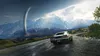 A classic car drives on a wet road with a massive tornado in the background, set against a backdrop of mountains. Produktbild-Vorschau