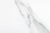 A close-up view of a white marble surface with gray veining. Produktbild-Vorschau