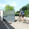 A person on a bicycle is passing through an automated gate. Anteprima dell’immagine prodotto