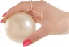 A hand holding a pearl-like ball. Anteprima dell’immagine prodotto