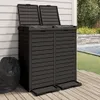 A dark gray outdoor trash can with two compartments, placed on a wooden deck next to a swimming pool. Voir les images du produit