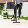 A person is using a wet/dry vacuum cleaner outdoors on a paved patio area. Anteprima dell’immagine prodotto