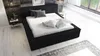 A modern bedroom with a black upholstered bed. Produktbild-Vorschau