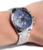 A man's wrist wearing a silver and blue Festina chronograph watch. Produktbild-Vorschau