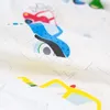 A close-up, folded view of a white fabric with a colorful car pattern. Produktbild-Vorschau