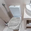 A toilet with a marble-patterned seat in a bathroom. Produktbild-Vorschau