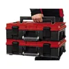 A person is holding two stacked red and black toolboxes. Anteprima dell’immagine prodotto
