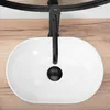 A top-down view of a white oval sink with a black faucet. Náhľad obrázku produktu