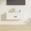 A white wall-mounted cabinet with two doors, each featuring a brown leather handle. The cabinet is adorned with decorative items, including framed artwork and a small potted plant. A television is mounted above it. Anteprima dell’immagine prodotto