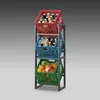A three-tiered metal rack holding plastic crates filled with beverages and fruit. Podgląd zdjęcia produktu