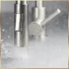 A close-up shot of a kitchen faucet with water spraying out. Náhľad obrázku produktu