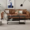A modern living room with a brown leather couch, a black coffee table, and artwork on the wall. Anteprima dell’immagine prodotto
