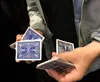 A person's hands are shown performing a card trick with a deck of cards. Produktbild-Vorschau