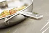A close-up shot of a frying pan with food inside, resting on a countertop. Voir les images du produit
