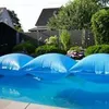 Blue pool air cushions floating on a swimming pool with a house and trees in the background. Produktbild-Vorschau
