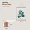 A poster hanging on a wall with a close-up detail of the wooden frame and dimensions. Produktbild-Vorschau