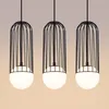 Three black pendant lights with white spherical bulbs hanging against a gradient background. Podgląd zdjęcia produktu