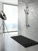 A modern bathroom with a shower tray and shower fixture. Produktbild-Vorschau