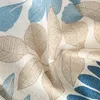 A close-up view of a fabric with a leaf pattern. Produktbild-Vorschau