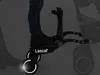 A person's legs and feet are shown standing on a black Lascal Buggy Board Maxi attached to a stroller. Produktbild-Vorschau