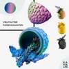 A collage of 3D printed dragon figures in various colors, with one large dragon emerging from a cracked egg. Produktbild-Vorschau