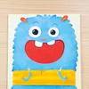 A colorful illustration of a friendly blue monster holding a fork and knife, ready to eat. Podgląd zdjęcia produktu