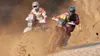 Two motorcyclists racing through a dusty desert. Produktbild-Vorschau