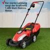 A red and black electric lawnmower is shown on a green lawn in front of a white picket fence. Produktbild-Vorschau