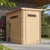 A wooden garden shed is shown outdoors on a paved patio, with a brick wall and greenery in the background. Produktbild-Vorschau