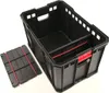 A black plastic storage crate with red accents, shown with a separate lid or insert piece. Voir les images du produit