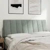 A close-up view of a bed with a light gray upholstered headboard and white bedding. Anteprima dell’immagine prodotto
