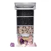 A multi-layered water filter with different filtering materials, including charcoal and gemstones. Produktbild-Vorschau