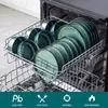 A dishwasher rack filled with green ceramic plates and bowls. Náhled obrázku produktu