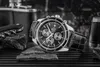 A black leather-strapped Casio Edifice chronograph watch is displayed on a textured surface, with a corkscrew and a flask in the background. Produktbild-Vorschau