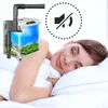 A woman sleeping peacefully next to a small aquarium, with a "mute" symbol overlayed. Podgląd zdjęcia produktu