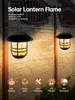 Two solar-powered lanterns with a flickering flame effect are hanging on a stone wall. Produktbild-Vorschau