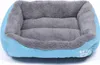 A blue and gray dog bed with a paw print logo on the side. Podgląd zdjęcia produktu