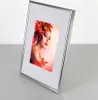 A silver picture frame with a photo of a woman with autumn leaves in her hair. Produktbild-Vorschau