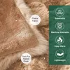 Close-up of a soft, plush blanket with labels indicating its features. Náhled obrázku produktu