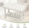 A white shower bench with arrows indicating airflow, placed on a light gray background with marketing icons and text at the bottom. Podgląd zdjęcia produktu