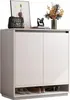 A minimalist shoe cabinet with decorative items on top. Náhled obrázku produktu