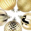 A close-up arrangement of several gold Christmas ornaments. Náhľad obrázku produktu