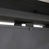 A close-up view of a black metal bracket and screw attaching two parts of a structure, likely a pergola. Produktbild-Vorschau